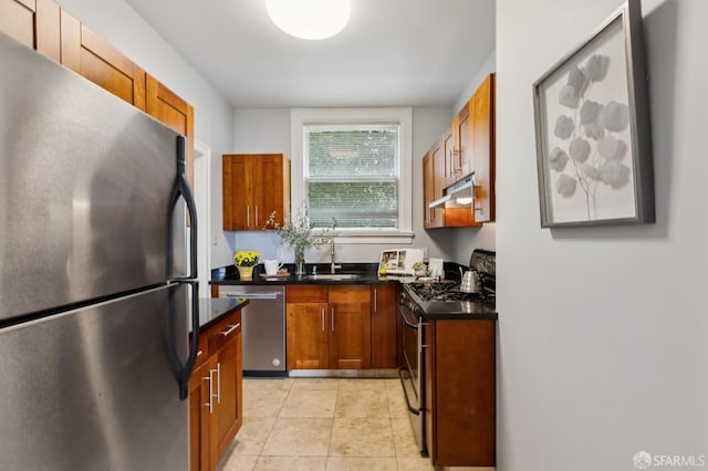 1250 Vallejo St Unit 9, San Francisco, CA 94109 - kitchen featuring appliances with stainless steel finishes, under cabinet range hood, dark countertops, light tile patterned floors, and brown cabinets