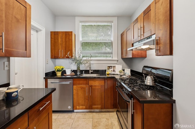 1250 Vallejo St Unit 9, San Francisco, CA 94109 - kitchen with appliances with stainless steel finishes, under cabinet range hood, brown cabinetry, and dark stone counters