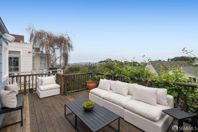 wooden terrace with an outdoor hangout area