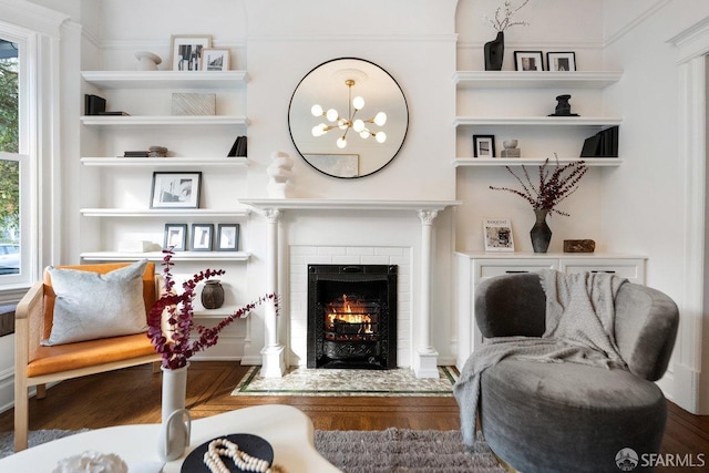 sitting room featuring a fireplace and wood finished floors