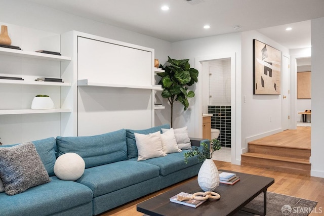 living room featuring stairway, recessed lighting, light wood-style flooring, and baseboards