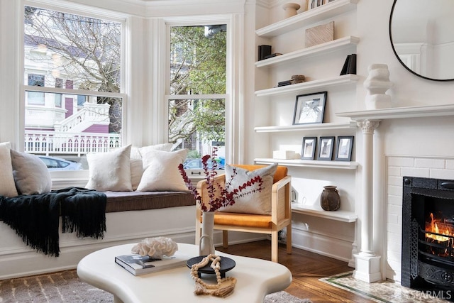 living area with a fireplace and wood finished floors