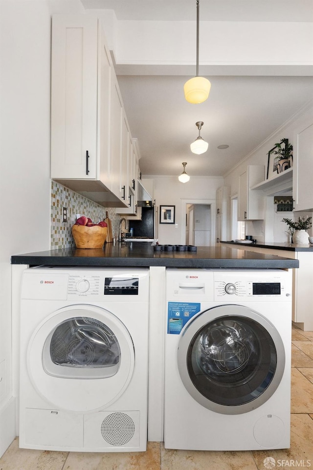 clothes washing area featuring light tile patterned floors and washing machine and clothes dryer