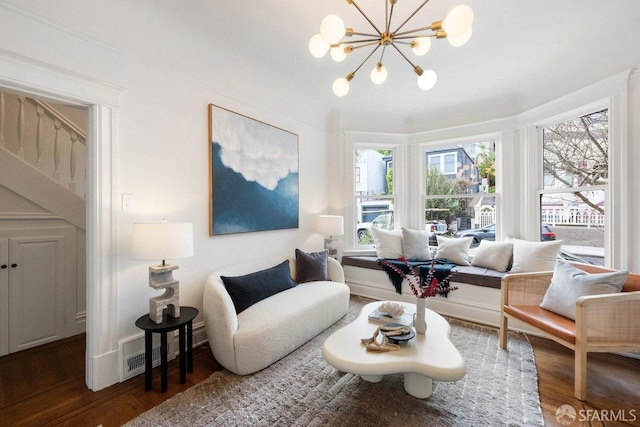 interior space featuring a chandelier, visible vents, and wood finished floors