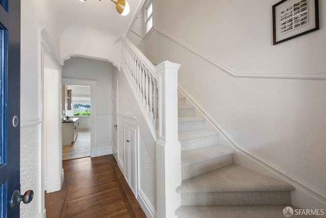 stairs featuring wood finished floors