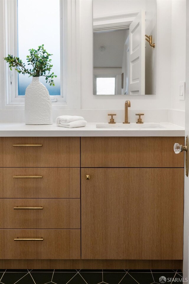 bathroom featuring a healthy amount of sunlight, vanity, and tile patterned floors