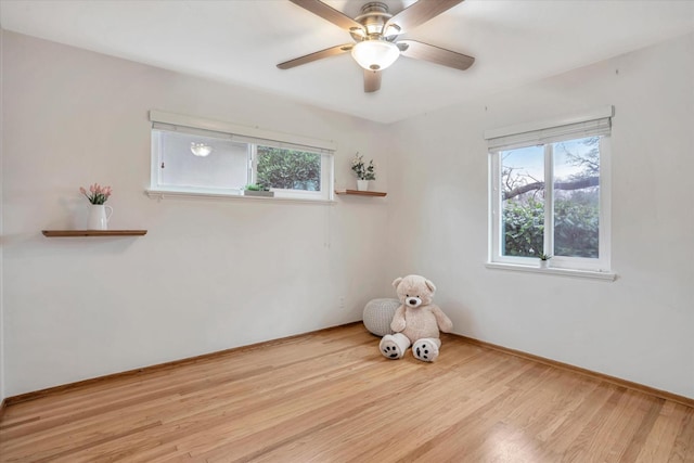 empty room with light hardwood / wood-style floors and ceiling fan