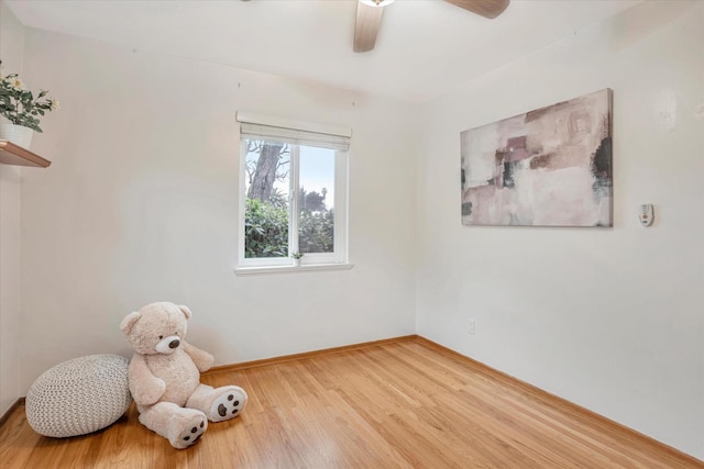 empty room featuring wood-type flooring and ceiling fan