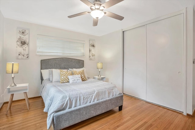 bedroom with hardwood / wood-style floors, ceiling fan, and a closet