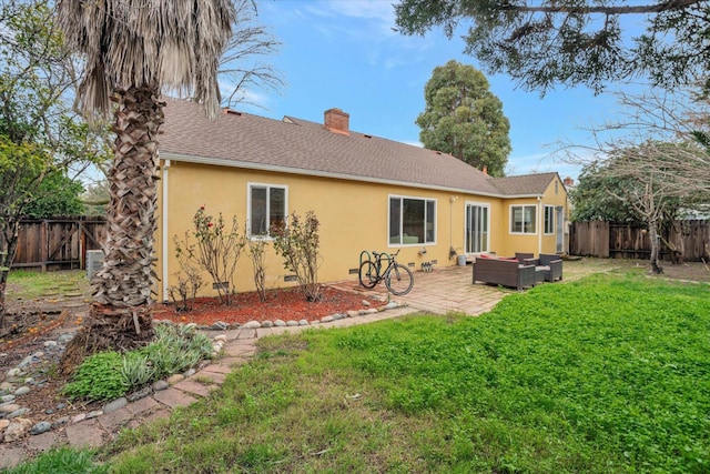 back of house featuring a patio, outdoor lounge area, and a yard