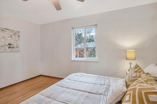 bedroom featuring hardwood / wood-style flooring and ceiling fan