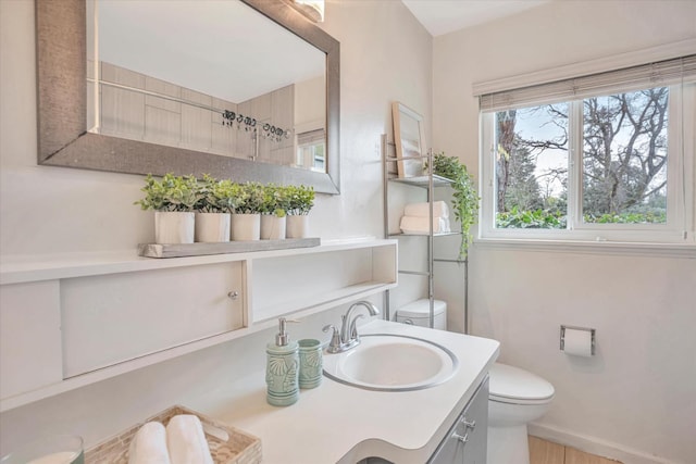 bathroom featuring vanity and toilet