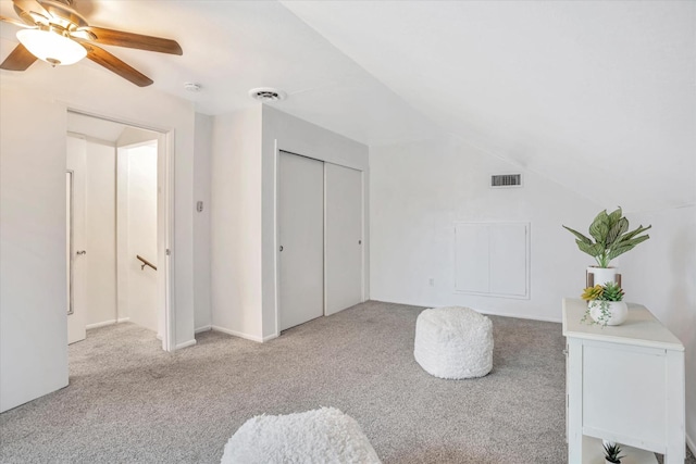 carpeted bedroom with lofted ceiling, ceiling fan, and a closet