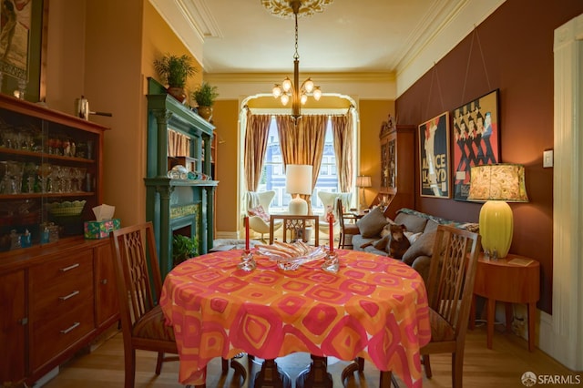772-774 14th St, San Francisco, CA 94114 - dining area featuring a chandelier, light wood finished floors, ornamental molding, and a fireplace