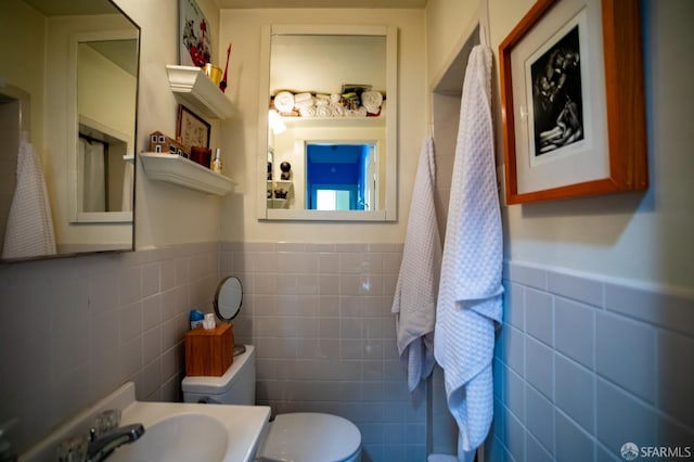 772-774 14th St, San Francisco, CA 94114 - bathroom with tile walls, toilet, a sink, and a wainscoted wall