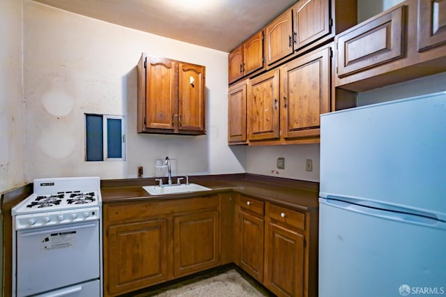 772-774 14th St, San Francisco, CA 94114 - kitchen with white appliances, a sink, brown cabinetry, and dark countertops