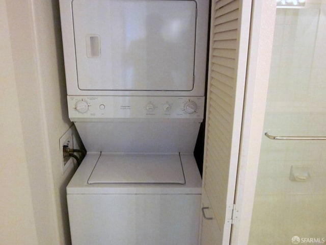 laundry area with stacked washer / dryer and laundry area