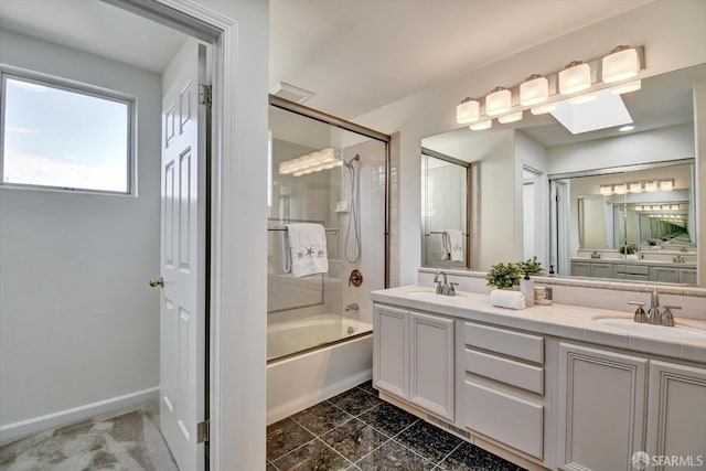 bathroom featuring shower / bathing tub combination, double vanity, baseboards, and a sink