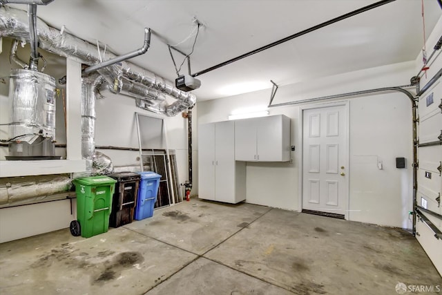 garage featuring a garage door opener and water heater