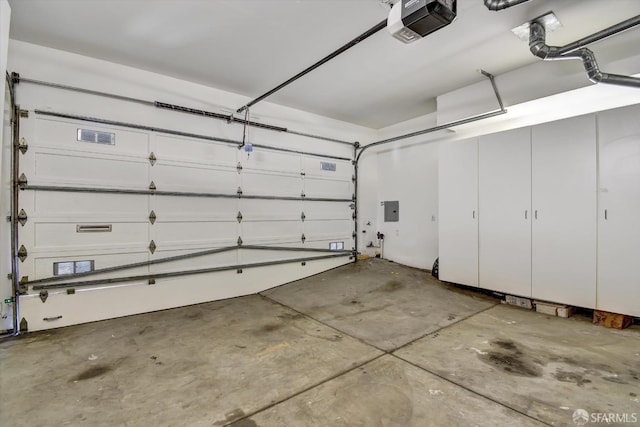 garage with electric panel and a garage door opener