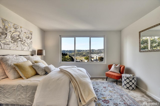 bedroom with baseboards, a mountain view, and carpet floors