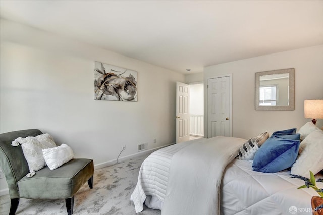 carpeted bedroom with visible vents and baseboards