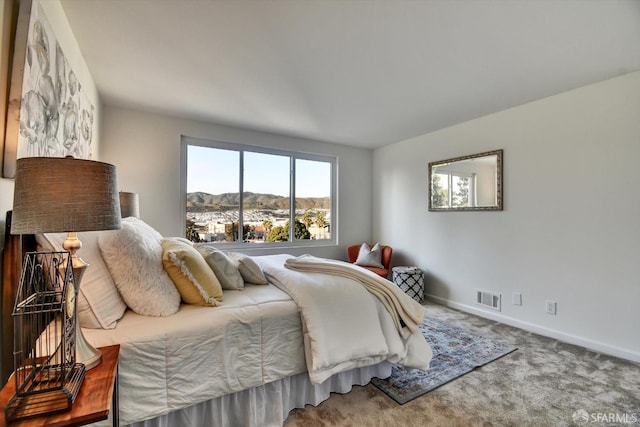 bedroom featuring a mountain view, carpet, visible vents, and baseboards