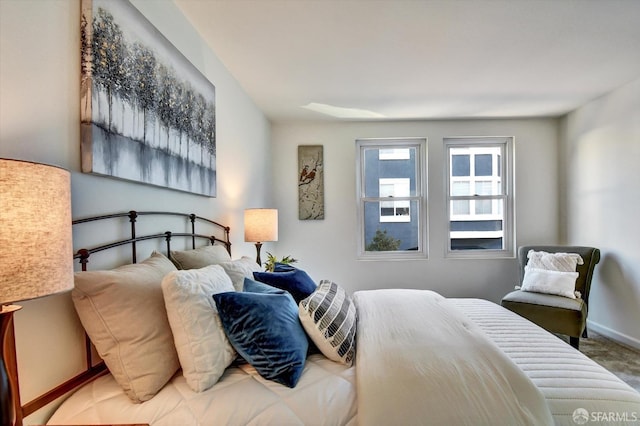 carpeted bedroom featuring baseboards