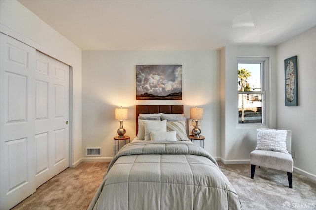 bedroom with visible vents, baseboards, and carpet