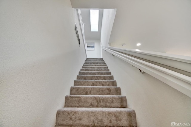 staircase featuring a skylight