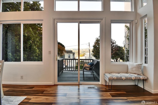 entryway with baseboards and wood finished floors