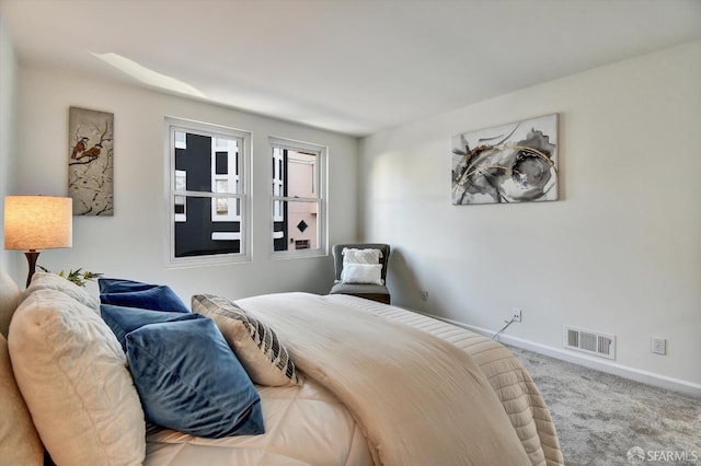 carpeted bedroom with baseboards and visible vents