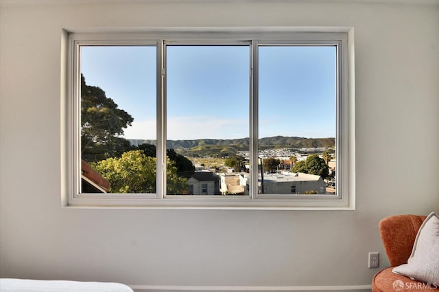 bedroom featuring a mountain view and baseboards