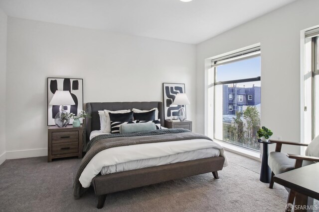 bedroom featuring carpet floors and baseboards