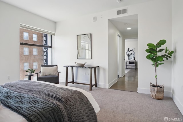 carpeted bedroom featuring visible vents and baseboards