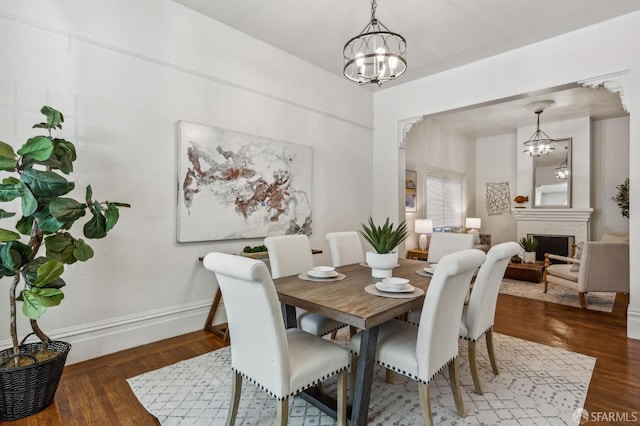 432 Buchanan St, San Francisco, CA 94102 - dining room featuring a chandelier, baseboards, wood finished floors, and a fireplace