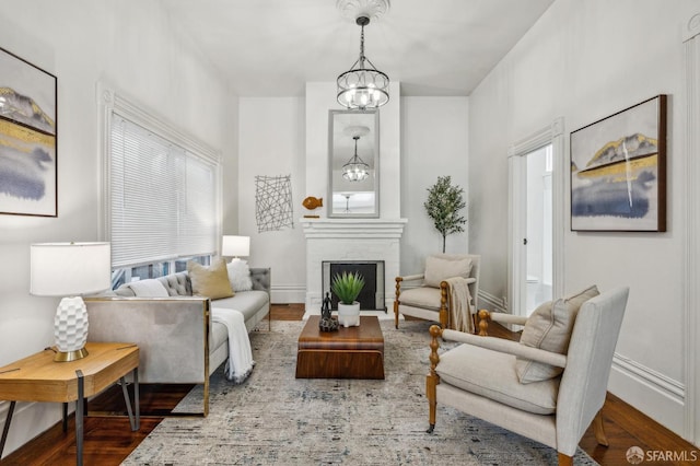 432 Buchanan St, San Francisco, CA 94102 - living room featuring a chandelier, wood finished floors, a fireplace, baseboards, and healthy amount of natural light