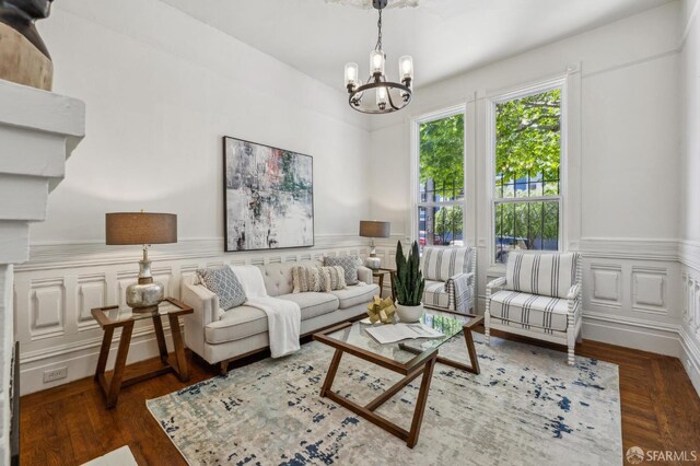 432 Buchanan St, San Francisco, CA 94102 - living room featuring a chandelier, wainscoting, wood finished floors, and a decorative wall
