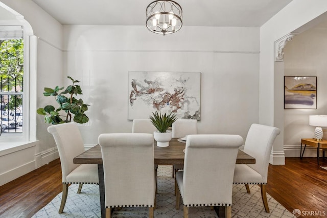 432 Buchanan St, San Francisco, CA 94102 - dining area featuring a chandelier, wood finished floors, and baseboards