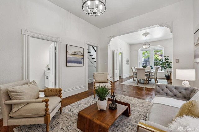 432 Buchanan St, San Francisco, CA 94102 - living room featuring a chandelier, stairs, wood finished floors, and baseboards