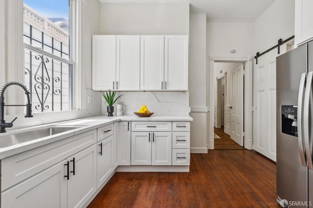 432 Buchanan St, San Francisco, CA 94102 - kitchen with stainless steel fridge, a sink, dark wood-type flooring, white cabinetry, and light countertops