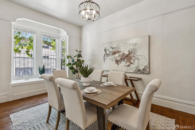 432 Buchanan St, San Francisco, CA 94102 - dining room featuring a chandelier, wood finished floors, and baseboards