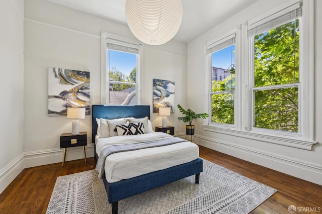 432 Buchanan St, San Francisco, CA 94102 - bedroom with multiple windows, baseboards, and wood finished floors