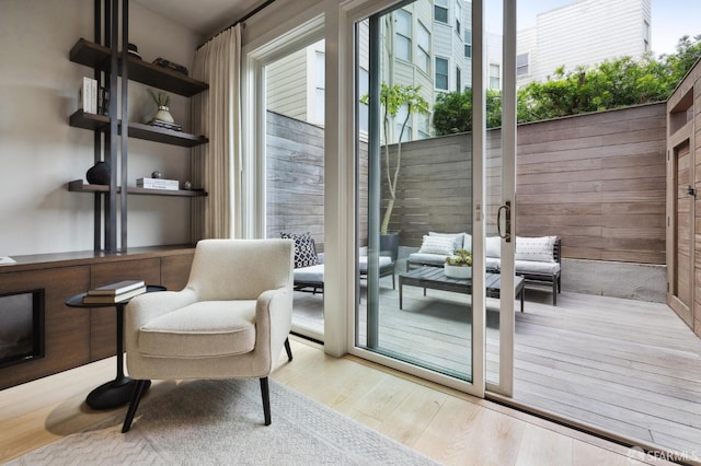 doorway to outside with wooden walls and light hardwood / wood-style floors