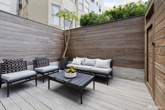 wooden terrace with outdoor lounge area