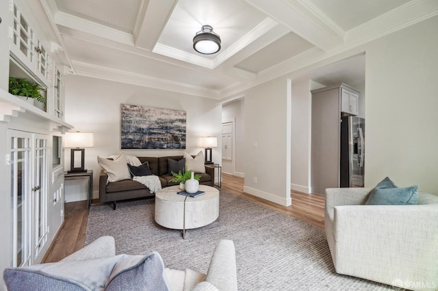 living room featuring crown molding, coffered ceiling, hardwood / wood-style flooring, and beamed ceiling