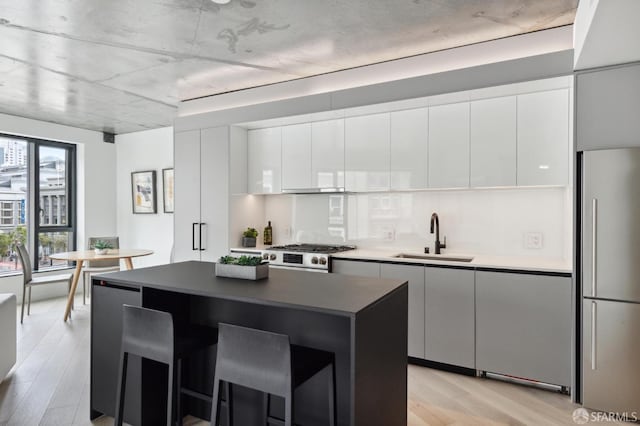 kitchen featuring light hardwood / wood-style floors, sink, white cabinetry, and stainless steel appliances