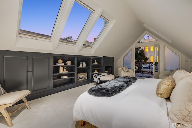 bedroom featuring lofted ceiling with skylight and light colored carpet