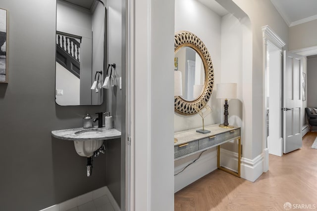 bathroom with baseboards and crown molding