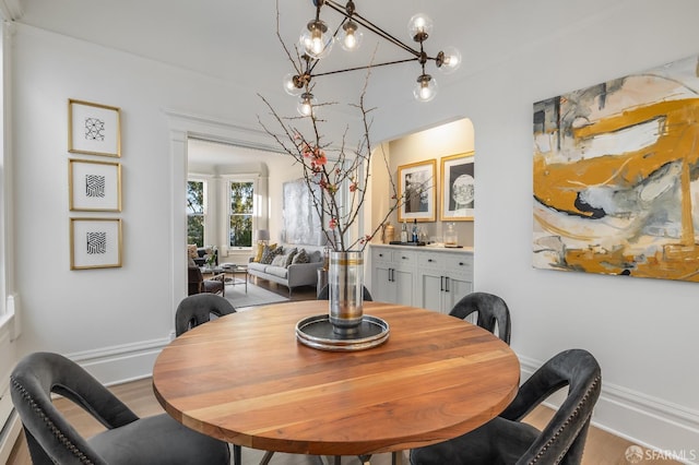 dining room featuring baseboards and light wood-style floors